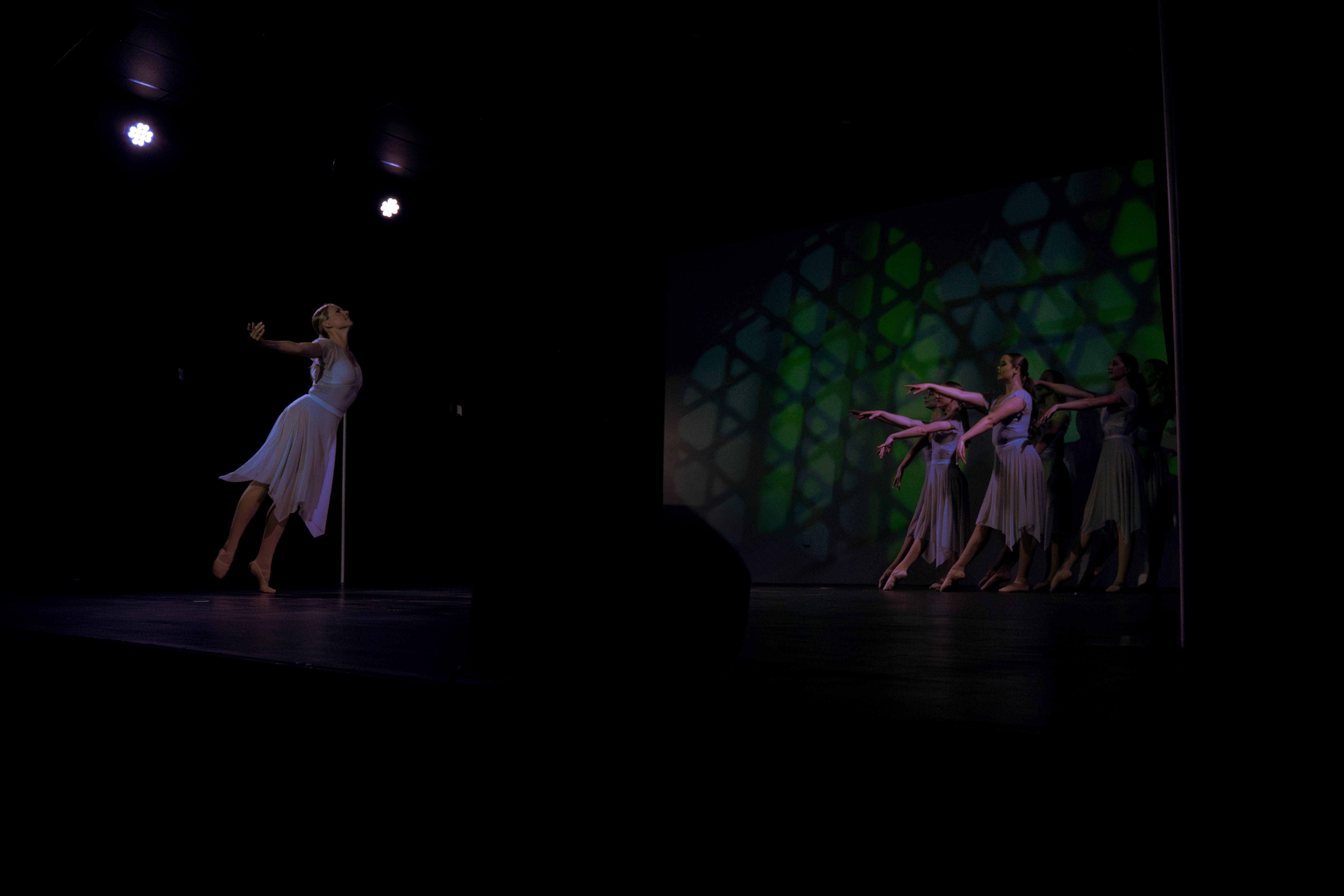 VelaDance soloist with ensemble on stage — South Jersey contemporary dance company performance