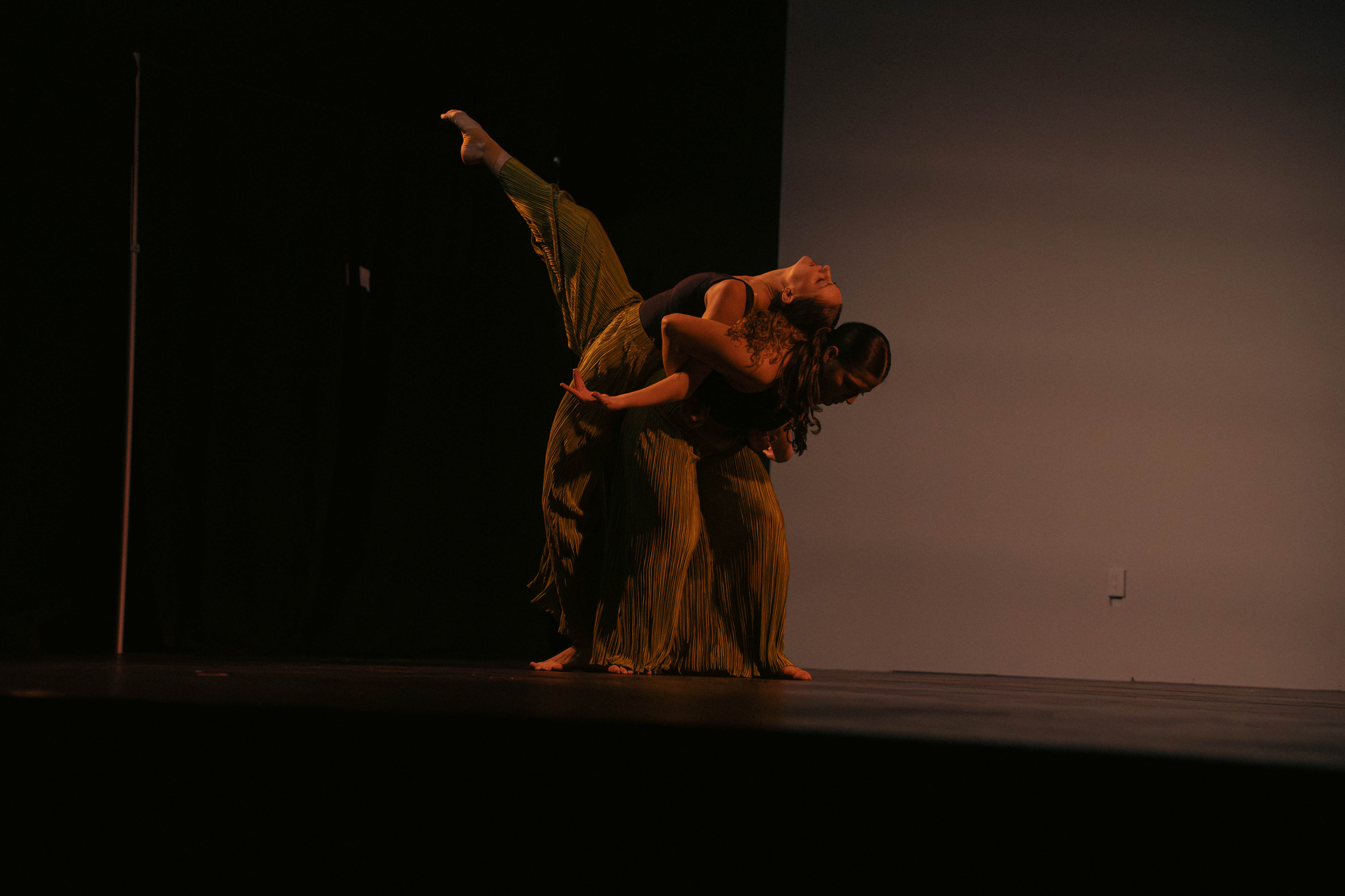 VelaDance duet in gold costumes during a concert dance performance — South Jersey dance company