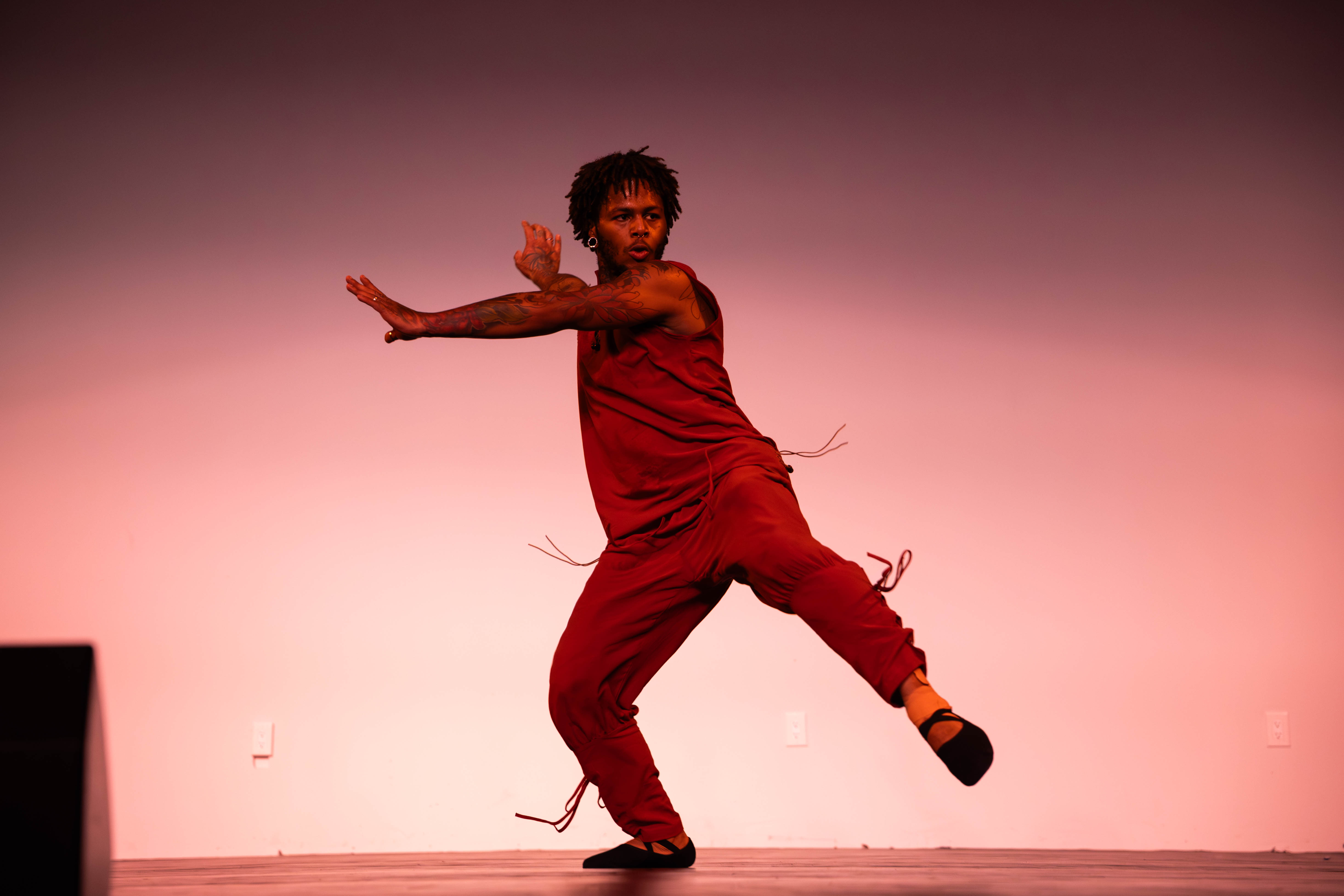 VelaDance soloist in red commanding the stage — New Jersey concert dance company performance