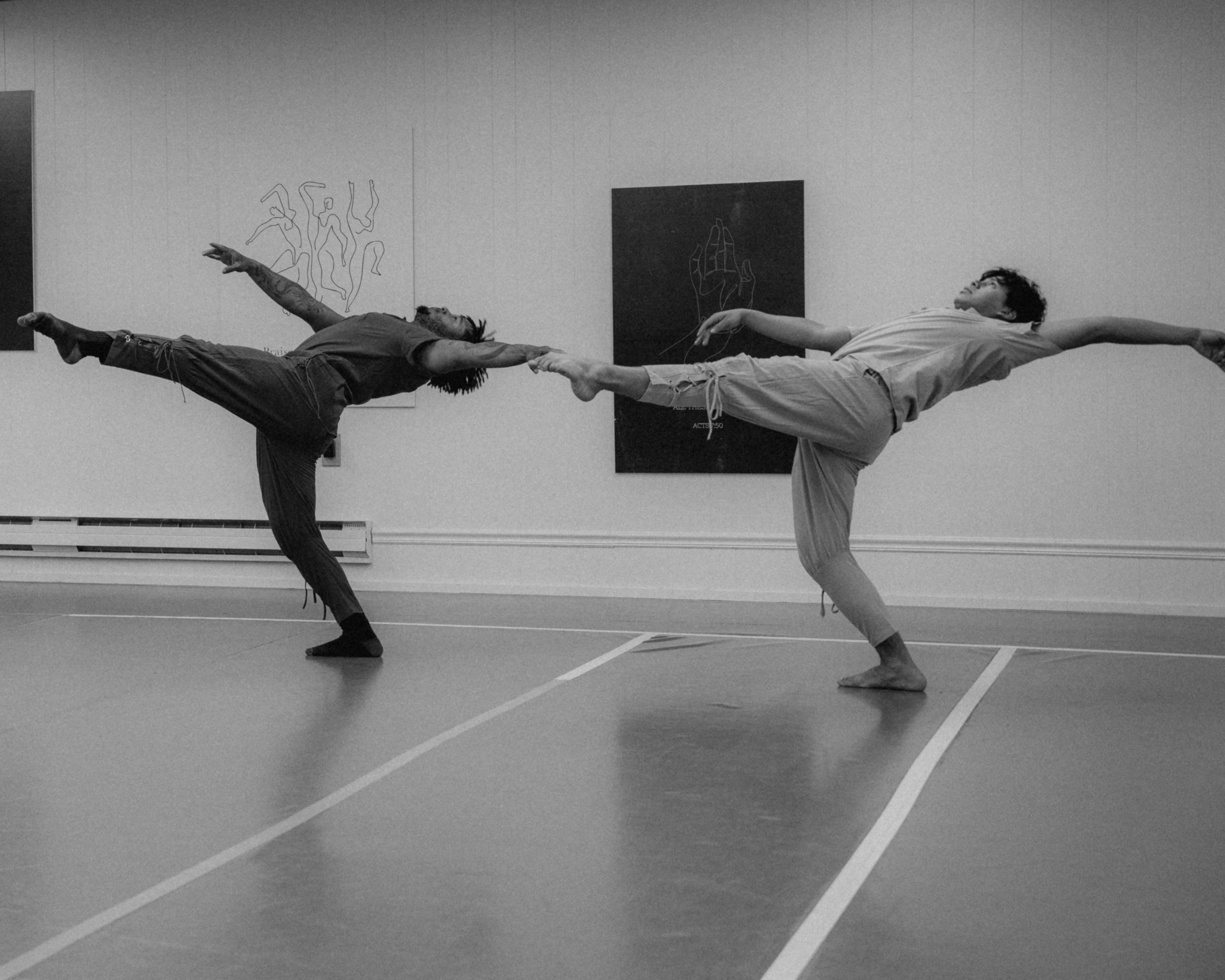 Two VelaDance dancers in mirrored penché during studio rehearsal — modern dance company New Jersey
